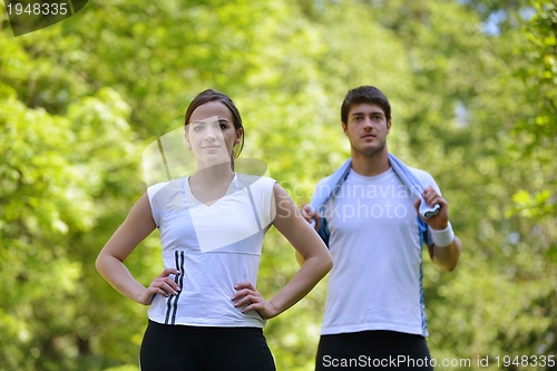 Image of Couple doing stretching exercise  after jogging