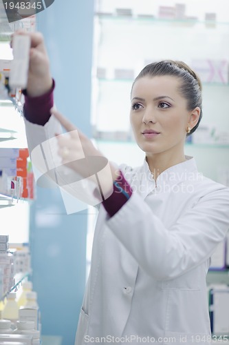 Image of pharmacist chemist woman standing in pharmacy drugstore
