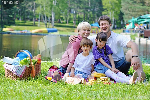 Image of Happy family playing together in a picnic outdoors