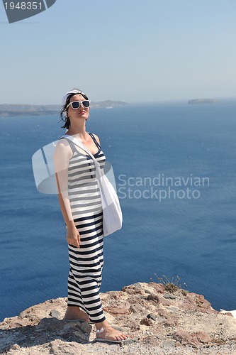 Image of Greek woman on the streets of Oia, Santorini, Greece