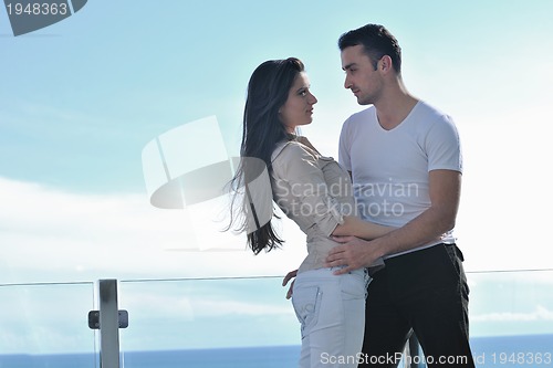 Image of couple relaxing on balcony