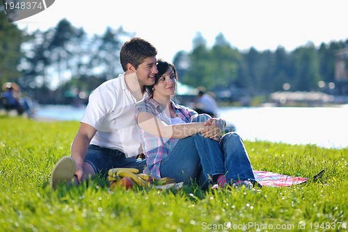 Image of happy young couple having a picnic outdoor