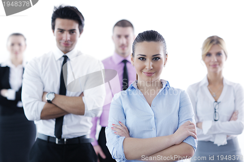 Image of business woman standing with her staff in background