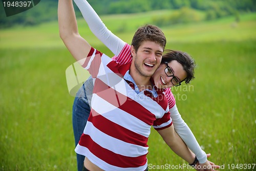 Image of Portrait of romantic young couple smiling together outdoor