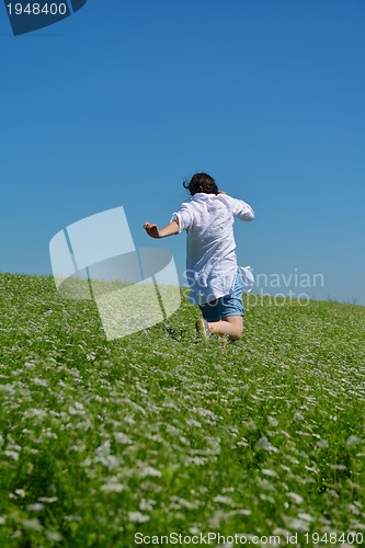 Image of Young happy woman in green field