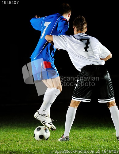 Image of football players in action for the ball