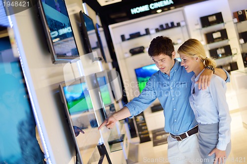 Image of Young couple in consumer electronics store