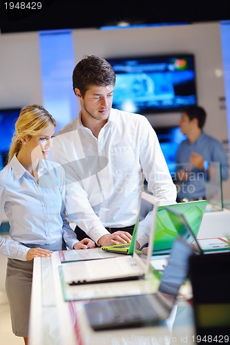 Image of Young couple in consumer electronics store