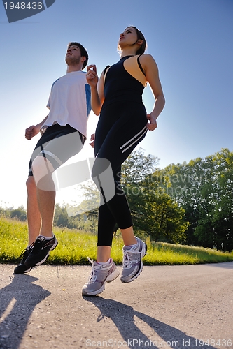 Image of Young couple jogging