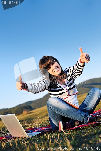 Image of young teen girl work on laptop outdoor