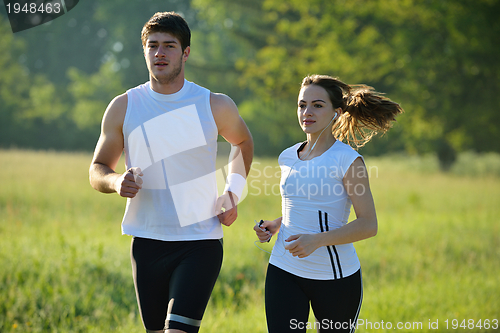 Image of Young couple jogging at morning