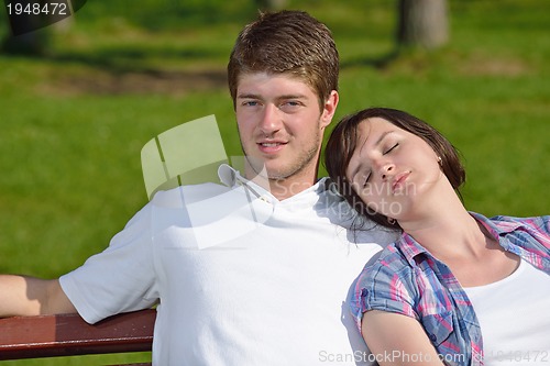 Image of Portrait of romantic young couple smiling together outdoor