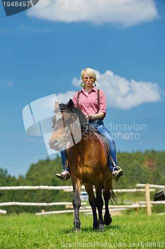 Image of happy woman  ride  horse