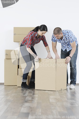 Image of Young couple moving in new home
