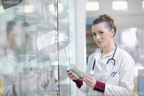 Image of pharmacist chemist woman standing in pharmacy drugstore