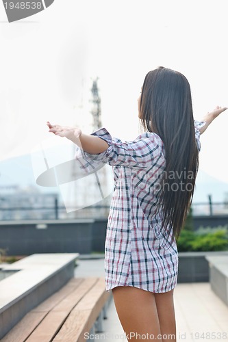 Image of beautiful young lady posing in garden