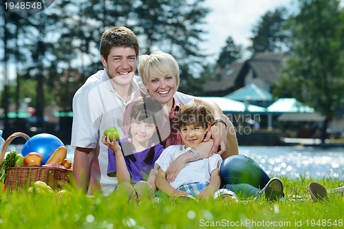 Image of Happy family playing together in a picnic outdoors