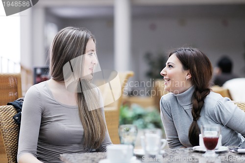 Image of cute smiling women drinking a coffee