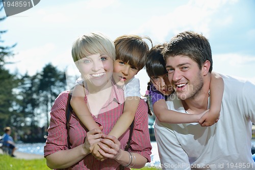 Image of happy young family have fun outdoors