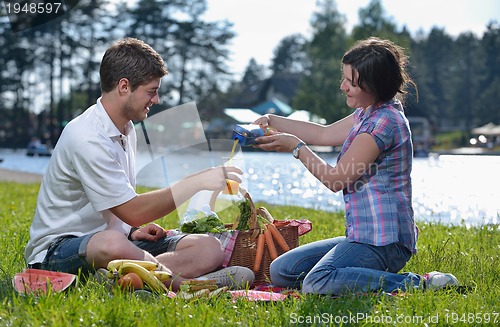 Image of happy young couple having a picnic outdoor