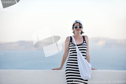 Image of Greek woman on the streets of Oia, Santorini, Greece