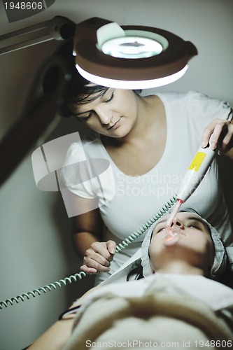 Image of woman with facial mask in cosmetic studio