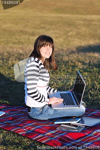 Image of young teen girl work on laptop outdoor