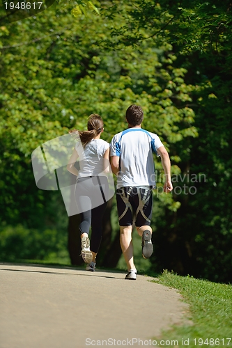 Image of Young couple jogging at morning