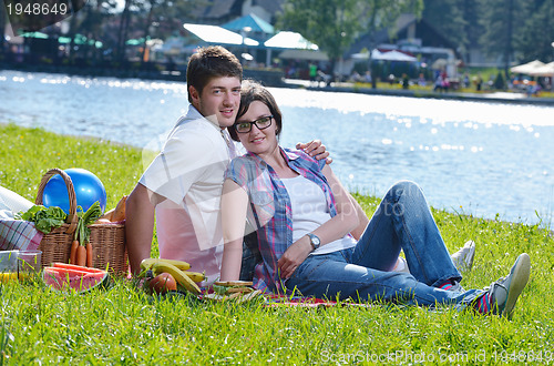 Image of happy young couple having a picnic outdoor