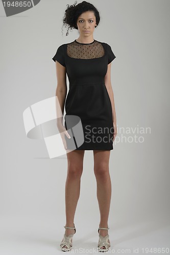 Image of elegant woman in fashionable dress posing in the studio