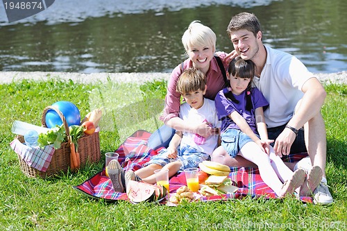 Image of Happy family playing together in a picnic outdoors
