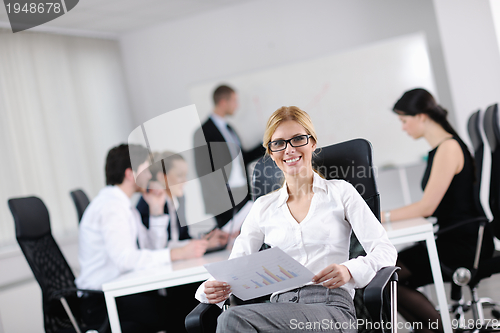 Image of business woman with her staff in background