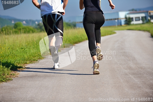 Image of Young couple jogging