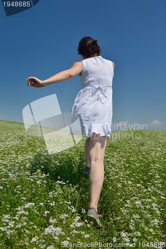 Image of Young happy woman in green field
