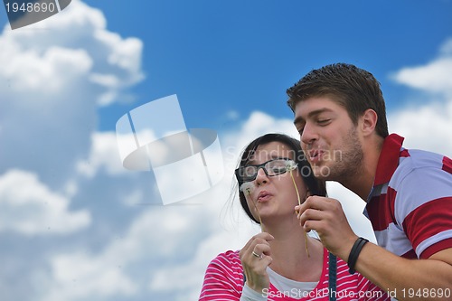 Image of Portrait of romantic young couple smiling together outdoor