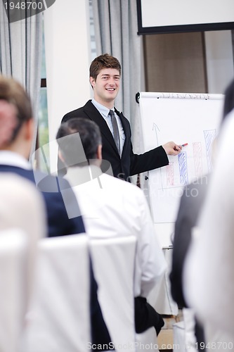 Image of Young  business man giving a presentation on conference