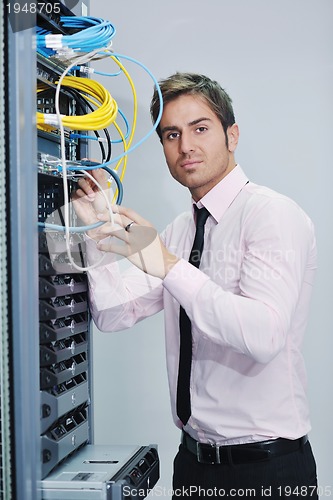 Image of young it engineer in datacenter server room