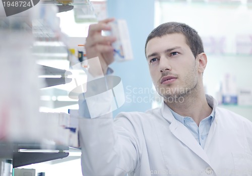Image of pharmacist chemist man in pharmacy drugstore