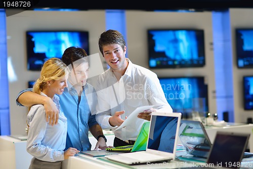 Image of Young couple in consumer electronics store