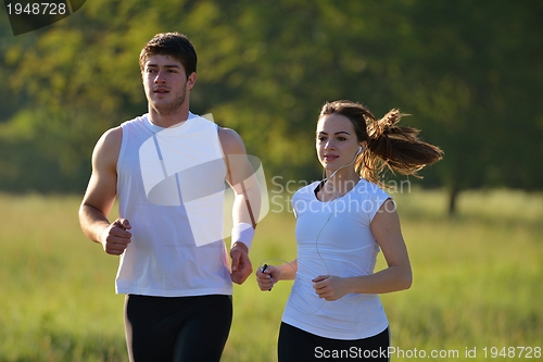 Image of Young couple jogging