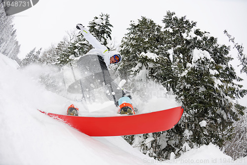 Image of snowboarder on fresh deep snow