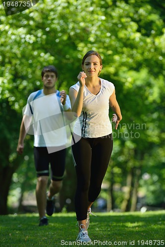 Image of Young couple jogging at morning