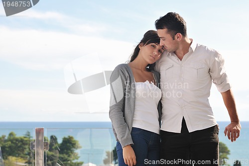 Image of couple relaxing on balcony