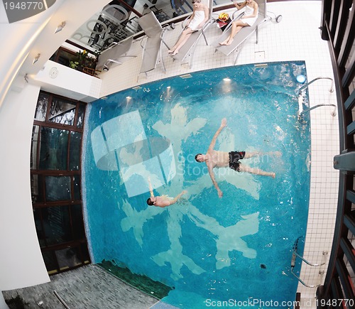 Image of young people group at spa swimming pool