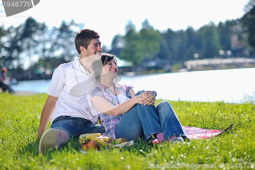 Image of happy young couple having a picnic outdoor