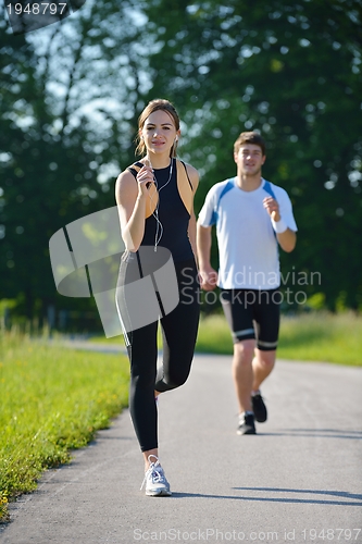 Image of Young couple jogging at morning