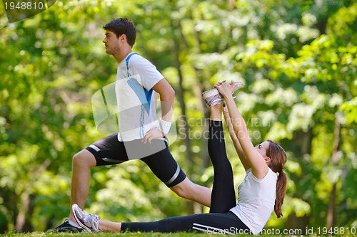 Image of Couple doing stretching exercise  after jogging