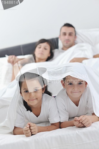 Image of happy young Family in their bedroom