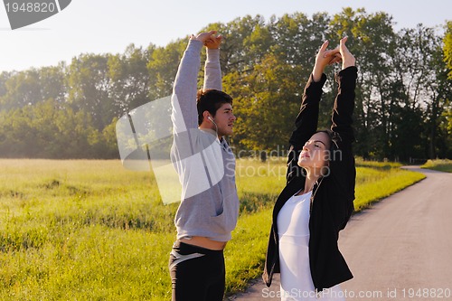 Image of Couple doing stretching exercise  after jogging