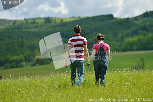 Image of Portrait of romantic young couple smiling together outdoor
